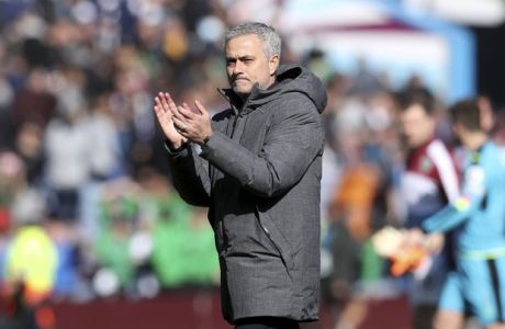 Manchester United manager Jose Mourinho applauds the fans after the English Premier League soccer match against  Burnley at Turf Moor, Burnley, England, Sunday April 23, 2017. (Martin Rickett/PA via AP)