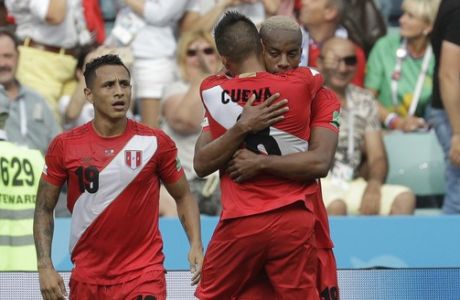 Peru's Andre Carrillo, right, celebrates with Peru's Yoshimar Yotun, left and Peru's Christian Cueva, after scoring his side's opening goal during the group C match between Australia and Peru, at the 2018 soccer World Cup in the Fisht Stadium in Sochi, Russia, Tuesday, June 26, 2018. (AP Photo/Gregorio Borgia)