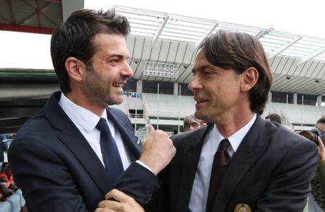 Milan coach Filippo Inzaghi, right, shares a word with Udinese coach Andrea Stramaccioni at the end of a Serie A soccer match between Udinese and Milan at the Friuli Stadium in Udine, Italy, Saturday, April 25, 2015. (AP Photo/Paolo Giovannini)