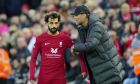Liverpool's manager Jurgen Klopp, right, gives instructions to Liverpool's Mohamed Salah during the English Premier League soccer match between Liverpool and Manchester City at Anfield stadium in Liverpool, Sunday, Oct. 16, 2022. (AP Photo/Jon Super)