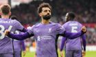 Liverpool's Mohamed Salah celebrates scoring his sides third goal during the English Premier League soccer match between Brentford and Liverpool at the Gtech Community Stadium in London, Saturday, Feb. 17, 2024. (AP Photo/Kirsty Wigglesworth)