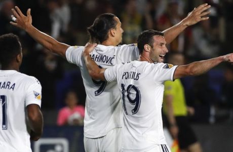LA Galaxy's Zlatan Ibrahimovic, center left, of Sweden, celebrates his goal with Chris Pontius, center right, Perry Kitchen, right, and Ola Kamara during the second half of an MLS soccer match against the Real Salt Lake Saturday, June 9, 2018, in Carson, Calif. The Galaxy won 3-0. (AP Photo/Jae C. Hong)