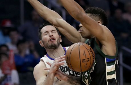 Los Angeles Clippers guard J.J. Redick, left, gets fouled by Milwaukee Bucks forward Giannis Antetokounmpo during the first half of an NBA basketball game in Los Angeles, Wednesday, March 15, 2017. (AP Photo/Chris Carlson)