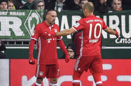 Bayern's Arjen Robben, right, celebrates after scoring the opening goal with assistant Franck Ribery, left, during the German Bundesliga soccer match between Werder Bremen and Bayern Munich in Bremen, Saturday, Jan. 28, 2017. (AP Photo/Martin Meissner)
