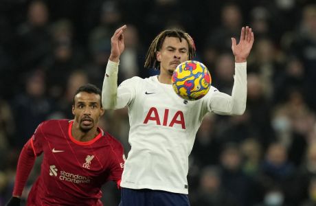 Tottenham's Dele Alli, right, duels for the ball with Liverpool's Joel Matip during the English Premier League soccer match between Tottenham Hotspur and Liverpool at the Tottenham Hotspur Stadium in London, Sunday, Dec. 19, 2021. (AP Photo/Frank Augstein)