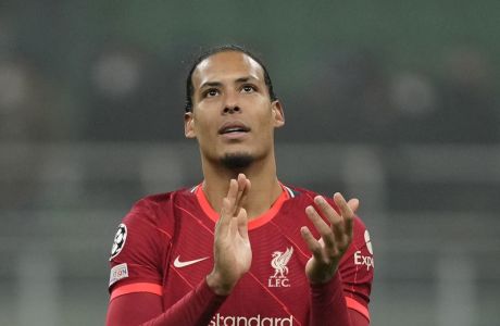 Liverpool's Virgil van Dijk applauds fans at the end of the Champions League, round of 16, first leg soccer match between Inter Milan and Liverpool at the San Siro stadium in Milan, Italy, Wednesday, Feb. 16, 2022. (AP Photo/Antonio Calanni)