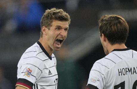 Germany's Thomas Muller, left, celebrates with Jonas Hofmann after scoring his side's third goal during the UEFA Nations League soccer match between Germany and Italy at Borussia Park in Monchengladbach, Germany, Tuesday, June 14, 2022. (AP Photo/Martin Meissner)