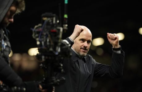 Manchester United's head coach Erik ten Hag applauds fans at the end of the Europa League playoff second leg soccer match between Manchester United and Barcelona at Old Trafford stadium in Manchester, England, Thursday, Feb. 23, 2023. Manchester United won 2-1. (AP Photo/Dave Thompson)