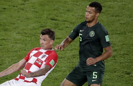 Croatia's Mario Mandzukic, left, and Nigeria's William Ekong challenge for the ball during the group D match between Croatia and Nigeria at the 2018 soccer World Cup in the Kaliningrad Stadium in Kaliningrad, Russia, Saturday, June 16, 2018. (AP Photo/Michael Sohn)