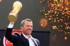 Former German soccer star Lothar Matthaus holds up the trophy during a ceremony to welcome the FIFA World Cup trophy at Manezh Square in Moscow, Russia, Sunday, June 3, 2018. (Kirill Zykov/Moscow News Agency photo via AP)