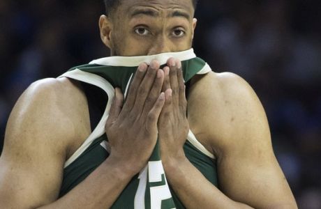 Milwaukee Bucks' Jabari Parker wipes his face with his jersey during the first half of the team's NBA basketball game against the Philadelphia 76ers, Wednesday, April 11, 2018, in Philadelphia. (AP Photo/Chris Szagola)