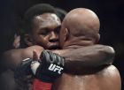 Nigeria's Israel Adesanya, left, hugs Brazil's Anderson Silva after winning their middlewesight bout at the UFC 234 event in Melbourne, Australia, Sunday, Feb. 10, 2019. (AP Photo/Andy Brownbill)
