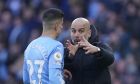 Manchester City's head coach Pep Guardiola, right, gives instructions to his player Joao Cancelo during the English Premier League soccer match between Manchester City and Manchester United, at the Etihad stadium in Manchester, England, Sunday, March 6, 2022. (AP Photo/Jon Super)