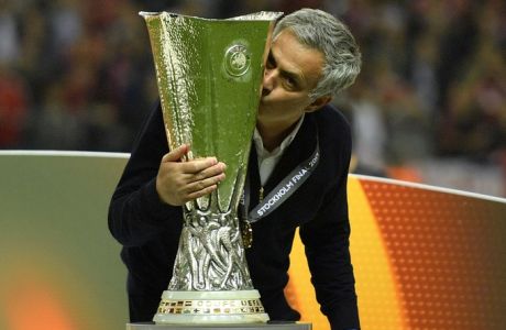 United manager Jose Mourinho kisses the trophy after winning the soccer Europa League final between Ajax Amsterdam and Manchester United at the Friends Arena in Stockholm, Sweden, Wednesday, May 24, 2017. United won 2-0. (AP Photo/Martin Meissner)