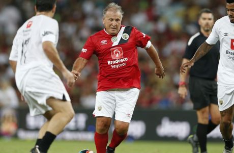 Former soccer player Zico, center, controls the ball during the Game of the Stars charity soccer match in Rio de Janeiro, Brazil, Wednesday, Dec. 28, 2016. This year the game also honored Brazil's Chapecoense soccer team. A chartered plane was carrying Chapecoense to the opening match in the Copa Sudamericana tournament's finals when it crashed outside Medellin on Nov. 28, killing 71 of the 77 people on board. (AP Photo/Silvia Izquierdo)