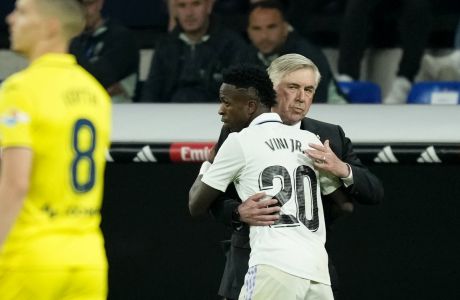 Real Madrid's Vinicius Junior celebrates with Real Madrid's head coach Carlo Ancelotti after scoring his side's second goal during a Spanish La Liga soccer match between Real Madrid and Villarreal at the Santiago Bernabeu stadium in Madrid, Saturday, April 8, 2023. (AP Photo/Jose Breton)