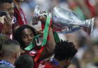 Portugal's Renato Sanches lifts the trophy after Portugal won the Euro 2016 final soccer match between Portugal and France at the Stade de France in Saint-Denis, north of Paris, Sunday, July 10, 2016. (AP Photo/Michael Sohn)