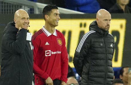 Manchester United's Cristiano Ronaldo stands next to Manchester United's head coach Erik ten Hag, right, waiting to replace teammate Anthony Martial during the Premier League soccer match between Everton and Manchester United at Goodison Park, in Liverpool, England, Sunday Oct. 9, 2022. (AP Photo/Jon Super)