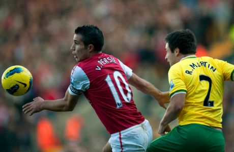Arsenal's Dutch striker Robin van Persie (L) vies with Norwich City's English defender Russell Martin (R) during the English Premier League football match between Norwich City and Arsenal at Carrow Road stadium in Norwich, England on November 19, 2011. AFP PHOTO/ADRIAN DENNIS

RESTRICTED TO EDITORIAL USE. No use with unauthorized audio, video, data, fixture lists, club/league logos or live services. Online in-match use limited to 45 images, no video emulation. No use in betting, games or single club/league/player publications. (Photo credit should read ADRIAN DENNIS/AFP/Getty Images)