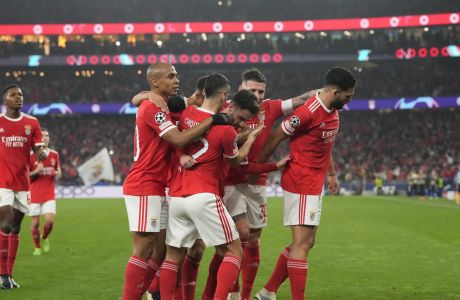 Benfica's Rafa Silva, third right, celebrates with his teammates after scoring his side's opening goal during the Champions League, round of 16, second leg soccer match between Benfica and Club Brugge at the Luz stadium in Lisbon, Portugal, Tuesday, March 7, 2023. (AP Photo/Armando Franca)