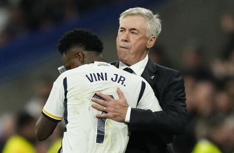 Real Madrid's Vinicius Junior celebrates with Real Madrid's head coach Carlo Ancelotti, right, after scoring his side's third goal during the Spanish La Liga soccer match between Real Madrid and Valencia at the Santiago Bernabeu stadium in Madrid, Spain, Saturday, Nov. 11, 2023. (AP Photo/Jose Breton)