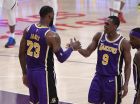 Los Angeles Lakers forward LeBron James, left, is congratulated by guard Rajon Rondo during the first half of the team's NBA basketball game against the Denver Nuggets on Wednesday, March 6, 2019, in Los Angeles. With the basket, James moved past Michael Jordan for fourth place on the NBA career scoring list. (AP Photo/Mark J. Terrill)