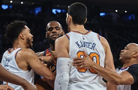 Cleveland Cavaliers' LeBron James, center, discusses with New York Knicks' Enes Kanter, center right, and Courtney Lee, center left, during the first half of a NBA basketball game at Madison Square Garden in New York, Monday, Nov. 13, 2017. (AP Photo/Andres Kudacki)