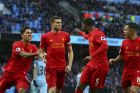 Liverpool's James Milner, center, celebrates after scoring the opening goal during the English Premier League soccer match between Manchester City and Liverpool at the Etihad Stadium in Manchester, England, Sunday March 19, 2017. (AP Photo/Dave Thompson)