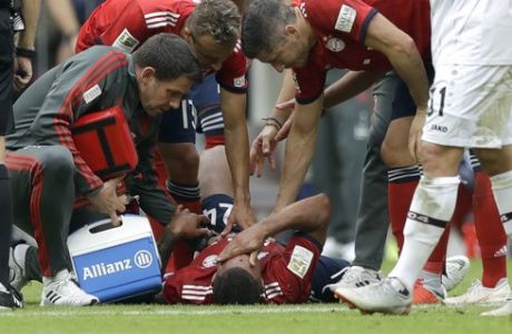 Bayern's Corentin Tolisso lies injured on the ground during the German Bundesliga soccer match between FC Bayern Munich and Bayer Leverkusen in Munich, Germany, Saturday, Sept. 15, 2018. (AP Photo/Matthias Schrader)