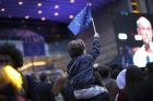 A young boy waves an EU flag as he watches a giant screen television outside the European Parliament in Brussels, Sunday, May 26, 2019. From Germany and France to Cyprus and Estonia, voters from 21 nations went to the polls Sunday in the final day of a crucial European Parliament election that could see major gains by the far-right, nationalist and populist movements that are on the rise across much of the continent. (AP Photo/Francisco Seco)