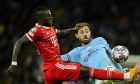 Bayern's Sadio Mane, left, fights for the ball with Manchester City's Bernardo Silva during the Champions League quarterfinal, first leg, soccer match between Manchester City and Bayern Munich at the Etihad stadium in Manchester, England, Tuesday, April 11, 2023. (AP Photo/Jon Super)