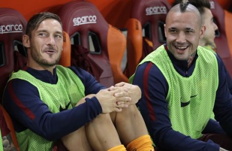 Romas Francesco Totti, left, sits next to Radia Nainggolan on the bench prior to a Serie A soccer match between Roma and Inter Milan, at Rome's Olympic Stadium, Sunday, Oct. 2, 2016. (AP Photo/Andrew Medichini)