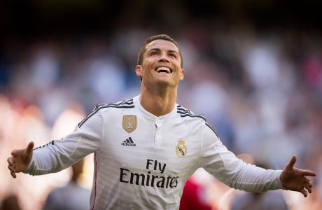FILE - In this Sunday April 5, 2015 file photo, Real Madrid's Cristiano Ronaldo celebrates scoring a goal during a La Liga soccer match against Granada at the Santiago Bernabeu stadium in Madrid. FIFA says Ronaldo is on a three-man shortlist for the rebranded FIFA's annual player award. All three candidates play for Spanish clubs. (AP Photo/Daniel Ochoa de Olza, File)