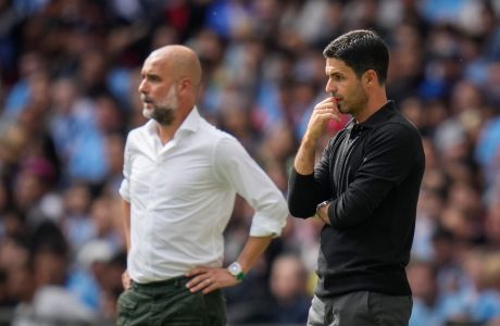 Manchester City's manager Pep Guardiola, left, and Arsenal's manager Mikel Arteta during the English FA Community Shield final soccer match between Arsenal and Manchester City at Wembley Stadium in London, Sunday, Aug. 6, 2023. (AP Photo/Kirsty Wigglesworth)