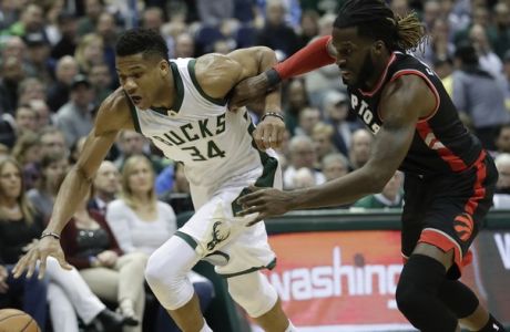 Milwaukee Bucks' Giannis Antetokounmpo drives past Toronto Raptors' DeMarre Carroll during the second half of Game 4 of an NBA first-round playoff series basketball game Saturday, April 22, 2017, in Milwaukee. The Raptors won 87-76 to tie the series 2-2. (AP Photo/Morry Gash)