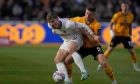 Manchester United's Rasmus Hojlund, left, is challenged by Newport's James Clarke during the FA Cup fourth round soccer match between Newport County and Manchester United at the Rodney Parade stadium in Newport, Wales, Sunday, Jan. 28, 2024. (AP Photo/Alastair Grant)