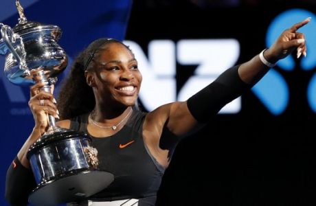 United States' Serena Williams holds her trophy after defeating her sister Venus during the women's singles final at the Australian Open tennis championships in Melbourne, Australia, Saturday, Jan. 28, 2017. (AP Photo/Dita Alangkara)