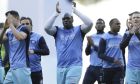 Wycombe Wanderers' Adebayo Akinfenwa, centre, and Wycombe Wanderers' Garry Thompson, right, applaud the away fans before the English FA Cup fourth round match between Tottenham Hotspur and Wycombe Wanderers at White Hart Lane in London, Saturday Jan. 28, 2017. (AP Photo/Tim Ireland)
