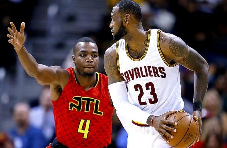 Cleveland Cavaliers forward LeBron James (23) is defended by Atlanta Hawks forward Paul Millsap (4) in the first half of an NBA basketball game on Sunday, April 9, 2017, in Atlanta. The Hawks won in overtime 126-125. (AP Photo/Todd Kirkland)