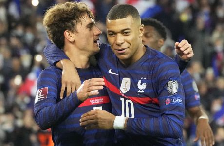 France's Antoine Griezmann celebrates with France's Kilian Mbappe after scoring a penalty, his side's seventh goal, during the World Cup 2022 group D qualifying soccer match between France and Kazakhstan at the Parc des Princes stadium in Paris, France, Saturday, Nov. 13, 2021. (AP Photo/Michel Euler)