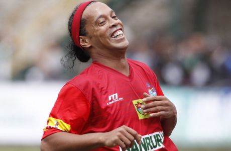 Brazil soccer star Ronaldinho, wearing the jersey of the Guatemalan club Municipal, reacts after missing a chance to score during a friendly soccer match against Comunicaciones in Guatemala City, Sunday, July 10, 2016. Ronaldinho played one half with each team. (AP Photo/Moises Castillo)