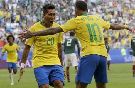 Brazil's Roberto Firmino, left, celebrates with Brazil's Neymar, right, after scoring his side's second goal during the round of 16 match between Brazil and Mexico at the 2018 soccer World Cup in the Samara Arena, in Samara, Russia, Monday, July 2, 2018. (AP Photo/Andre Penner)