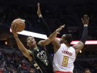 Milwaukee Bucks' Giannis Antetokounmpo shoots past Atlanta Hawks' Dwight Howard during the first half of an NBA basketball game Friday, March 24, 2017, in Milwaukee. (AP Photo/Morry Gash)