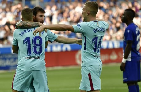 FC Barcelona's Lionel Messi, second left, celebrates his goal with Jordi Alba, and Gerard Deulofeu, right, after scoring during the Spanish La Liga soccer match between FC Barcelona and Deportivo Alaves, at Mendizorroza stadium, in Vitoria, northern Spain, Saturday, Aug. 26, 2017. (AP Photo/Alvaro Barrientos)