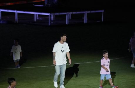 Inter Miami's Lionel Messi walks on the pitch during a celebration by the team at DRV PNK Stadium, Sunday, July 16, 2023, in Fort Lauderdale, Fla. It comes one day after Messi, Major League Soccer and Inter Miami finalized his signing through the 2025 season. (AP Photo/Rebecca Blackwell)