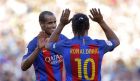 Former FC Barcelona player Frederic Dehu, center, celebrates after scoring with his teammate Ronaldinho, right, during the friendly soccer match between FC Barcelona legends and Manchester United legends at the Camp Nou stadium in Barcelona, Spain, Friday, June, 30, 2017. (AP Photo/Manu Fernandez)