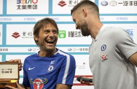 Chelsea's manager Antonio Conte, left, and Gary Cahill laugh as they participate in a press conference before the team's practice session at the National Stadium, also known as the Bird's Nest, in Beijing, Friday, July 21, 2017. Chelsea plays Arsenal in a friendly soccer match on Saturday. (AP Photo/Mark Schiefelbein)