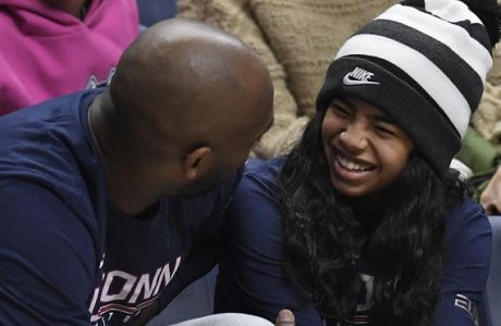 Kobe Bryant and his daughter Gianna watch the first half of an NCAA college basketball game between Connecticut and Houston, Saturday, March 2, 2019, in Storrs, Conn. (AP Photo/Jessica Hill)