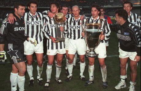 Juventus players present their trophies to fans at Turin's Delle Alpi stadium Sunday, December 1st, 1996, after a major league match against Bologna. Juventus won the Toyota Cup (left) last November 26 in Tokyo beating 1 - 0 Argentine South American champions of River Plate, and the Champions Cup, at right, last May in Rome, beating Ajax 5 - 3 after penalty kicks. (AP Photo/Carlo Fumagalli)