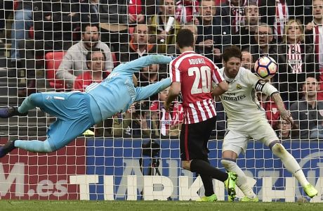 Real Madrid's goalkeeper Keylor Navas, left, and Sergio Ramos, fail to block the ball as Athletic Bilbao's Aritz Aduriz scores during the Spanish La Liga soccer match between Real Madrid and Athletic Bilbao, at San Mames stadium, in Bilbao, northern Spain, Saturday, March 18, 2017. (AP Photo/Alvaro Barrientos)